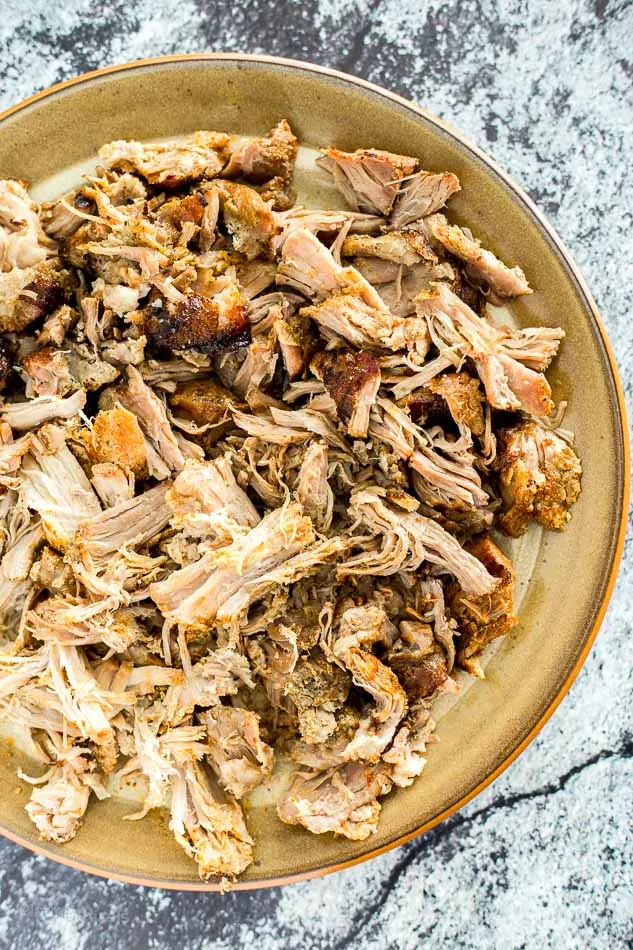 Tender shredded carnitas from slow cooker, perfect for enchiladas and Mexican dishes.