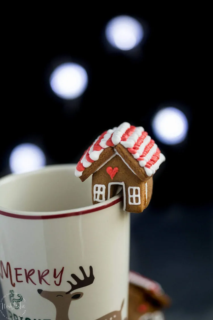 Christmas gingerbread house on mug with festive background, perfect for holiday decor.