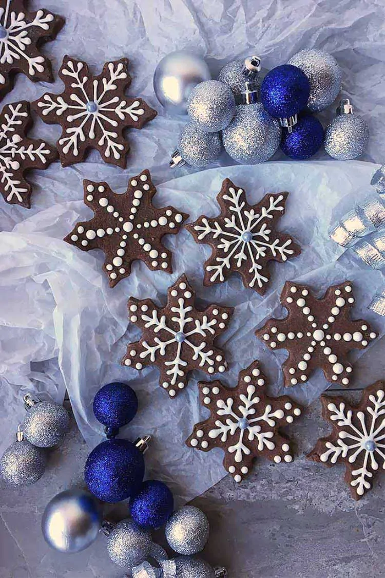 Festive decorated snowflake cookies with Christmas ornaments for holiday cheer.