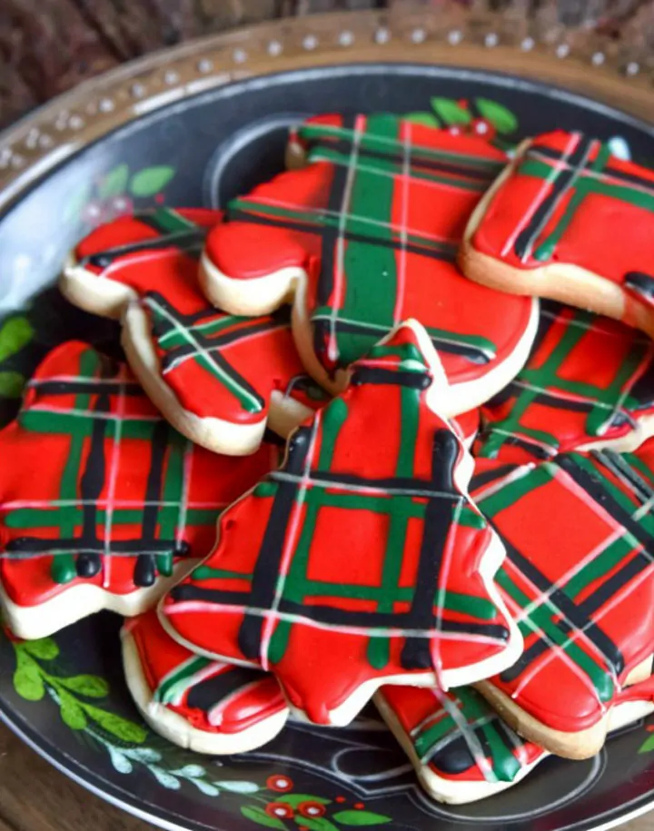 Festive Christmas cookies decorated with red, green, and black tartan plaid icing.