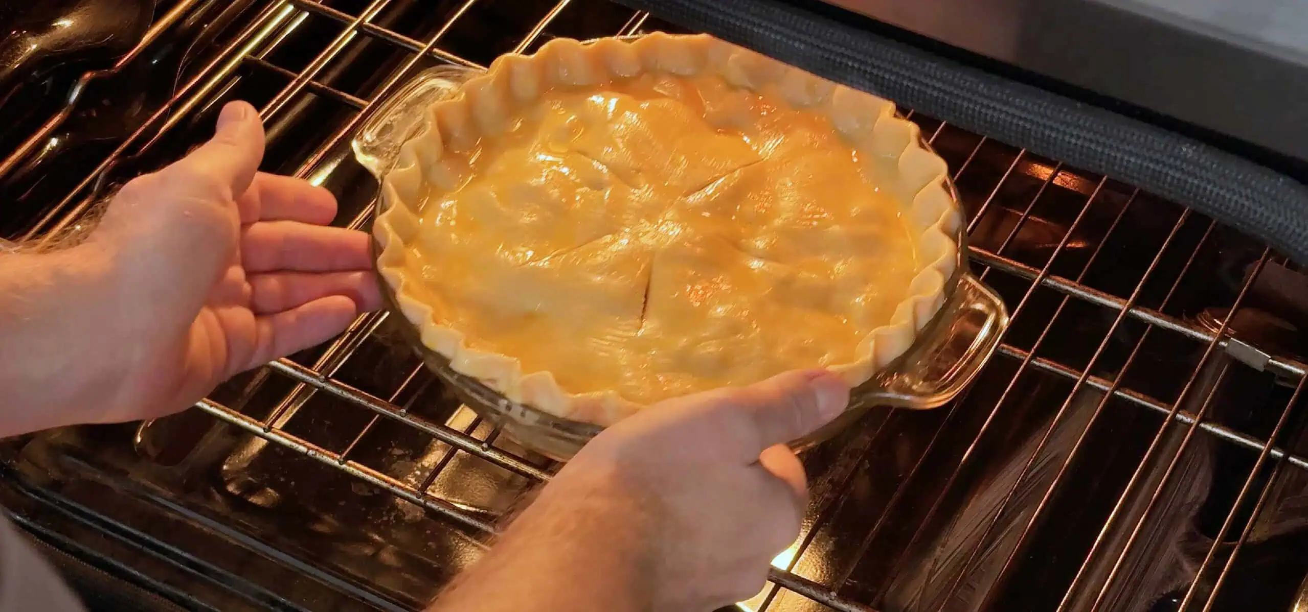 placing a homemade apple pie in an oven Placing a homemade apple pie in an oven