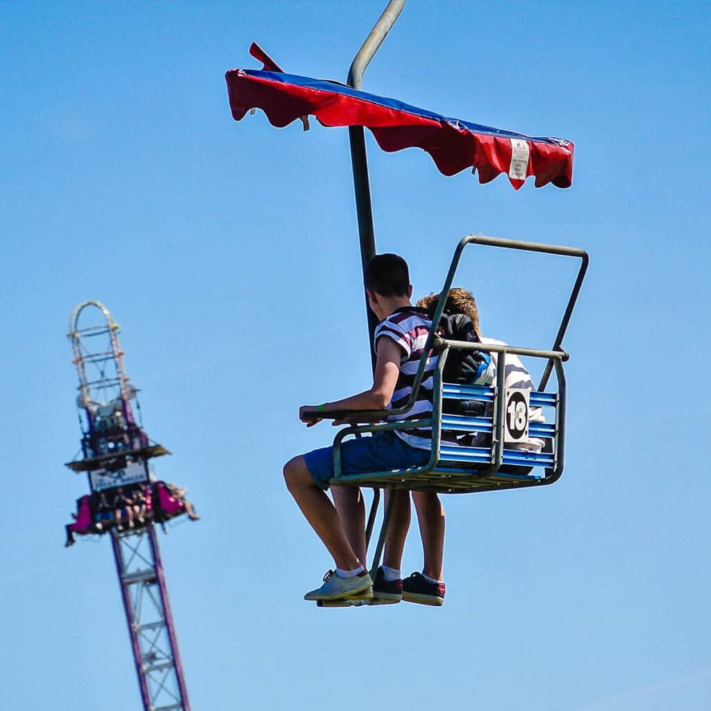 Young boy and young girl on a chairlift ride