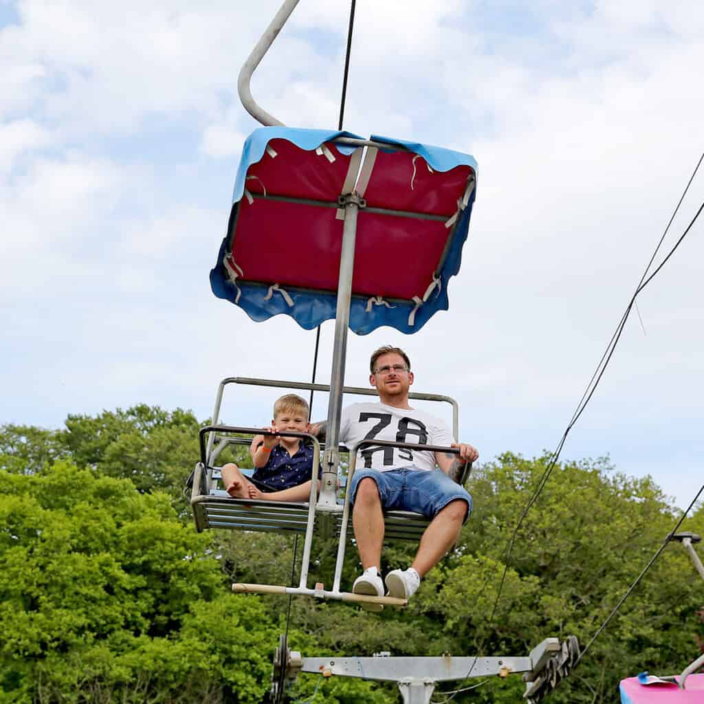 Man and young boy on a chairlift ride