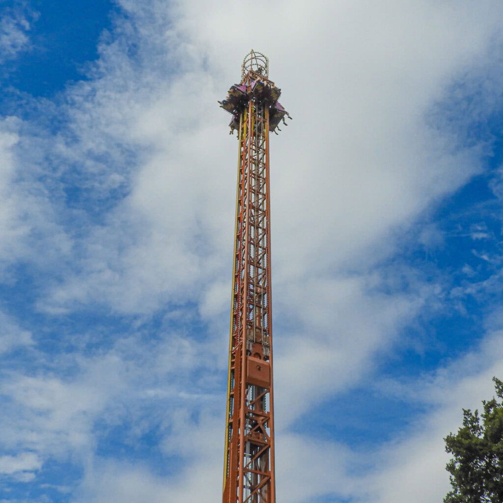 Low angle shot of a drop tower theme park ride