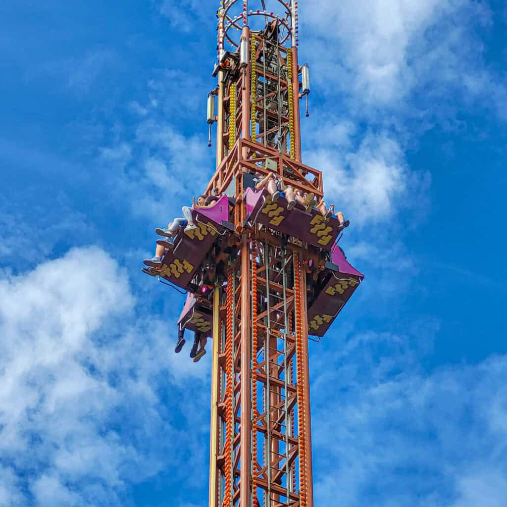 People on a drop tower theme park ride