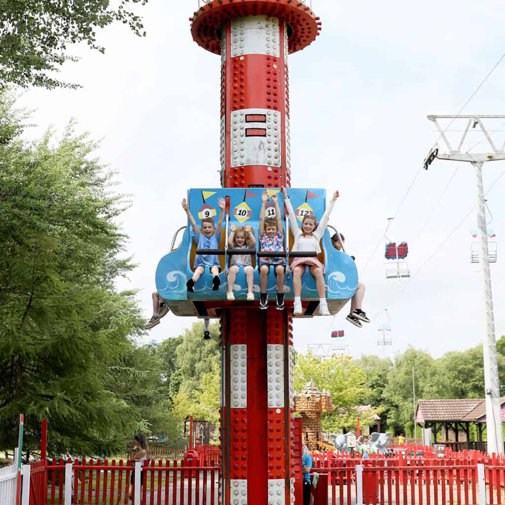 Group of children on a drop tower theme park ride
