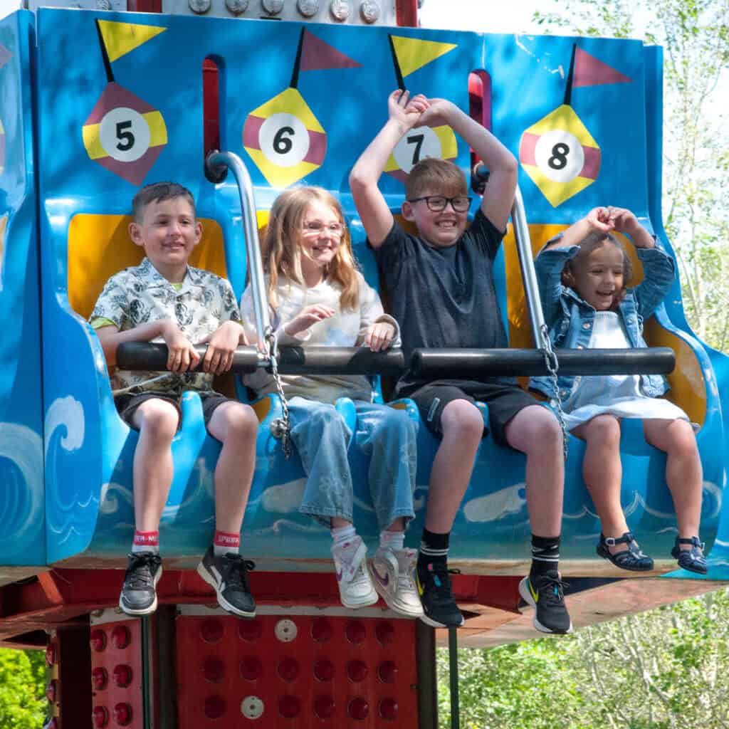 Group of children on a drop tower theme park ride