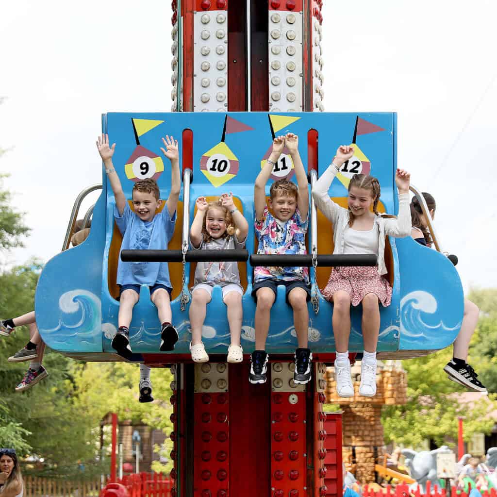 Group of children on a drop tower theme park ride
