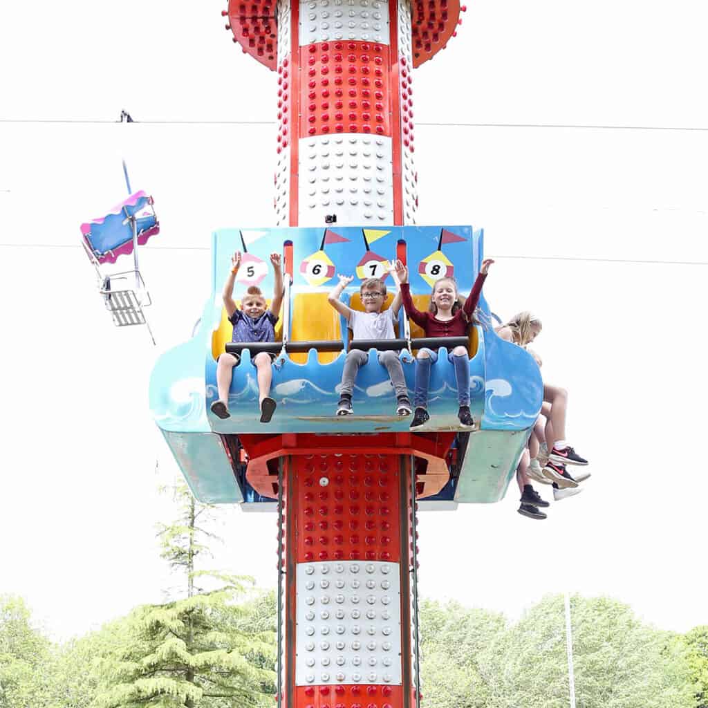 Group of children on a drop tower theme park ride