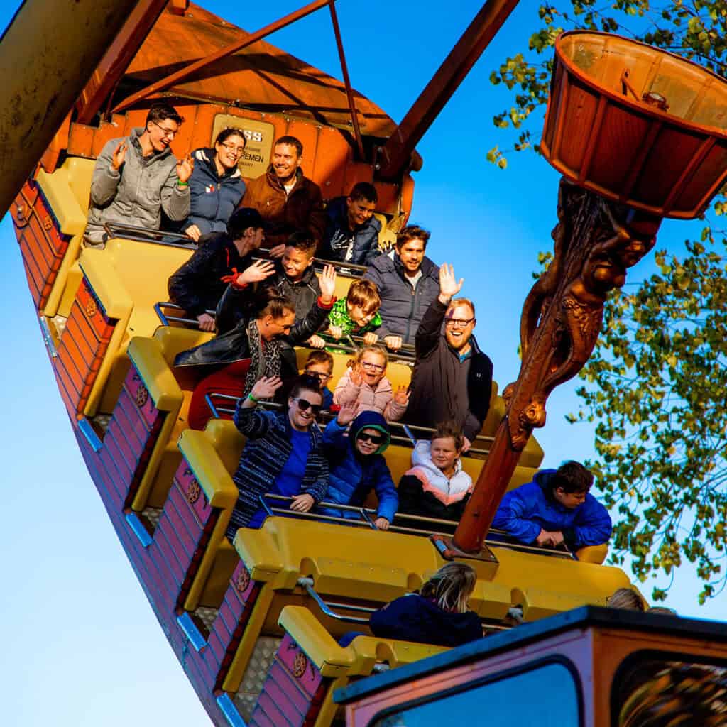 People on a pirate ship amusement park ride
