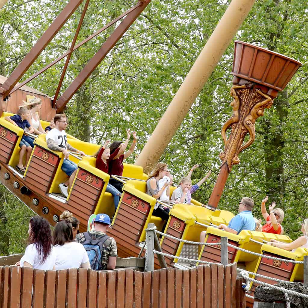 People on a pirate ship amusement park ride