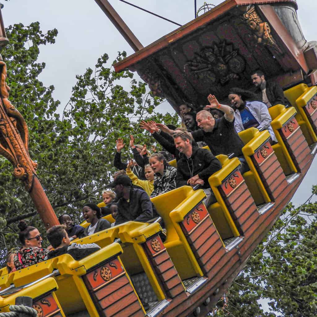 People on a pirate ship amusement park ride