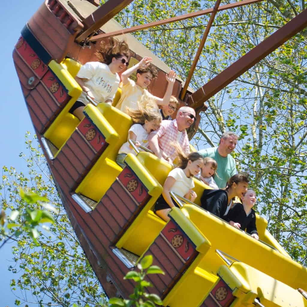People on a pirate ship amusement park ride
