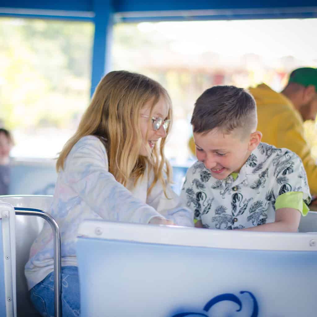 Young girl and young boy on a teacups ride