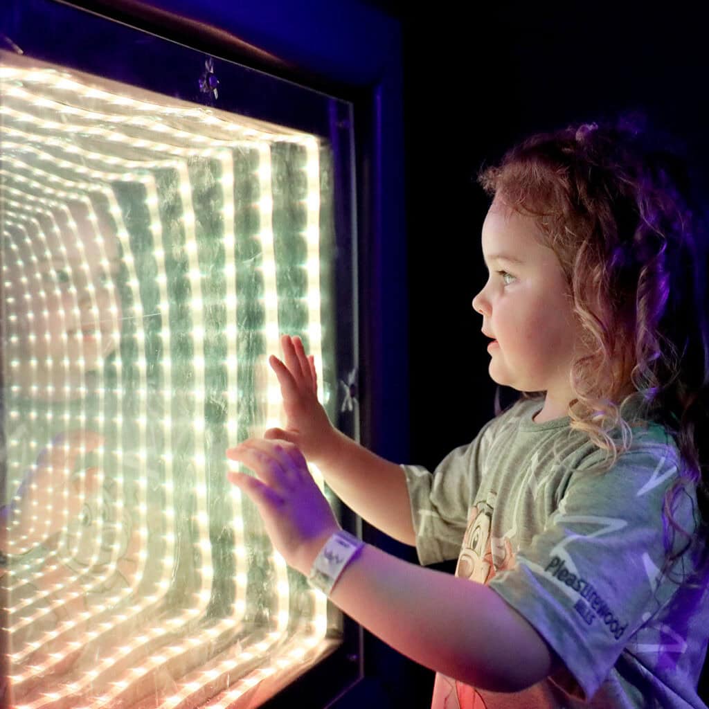 Young girl looking into lightbox