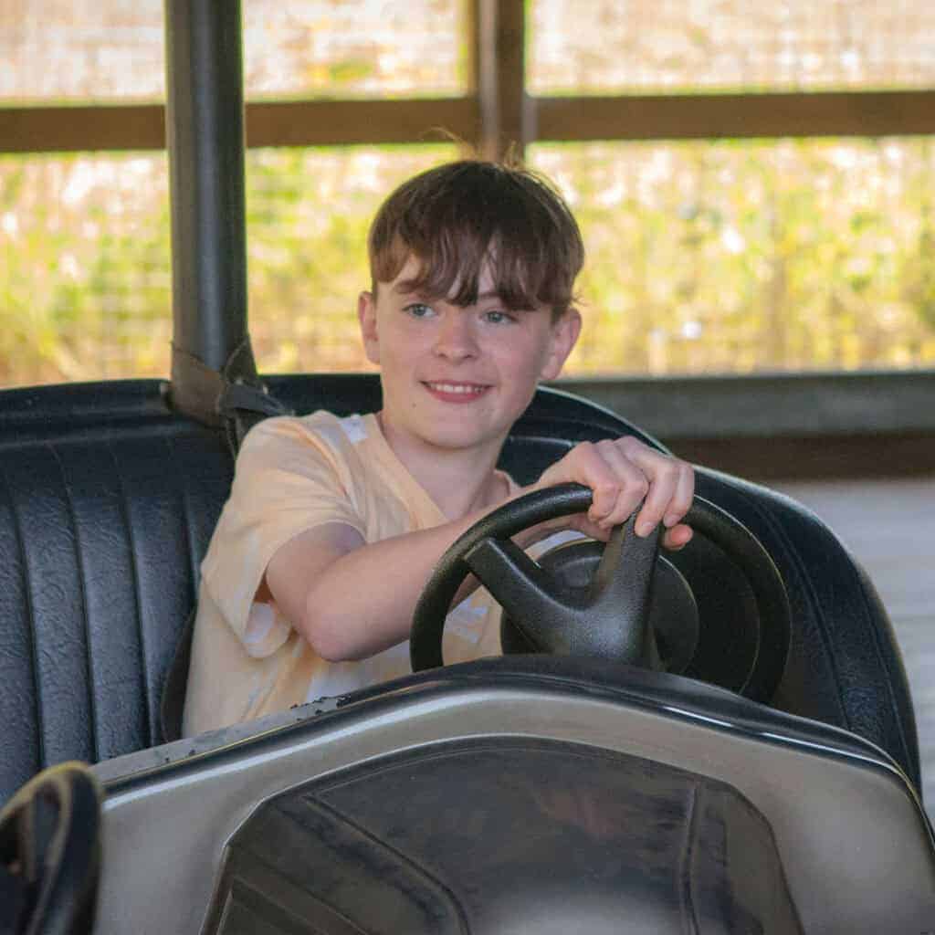 Young boy in blue dodgems car