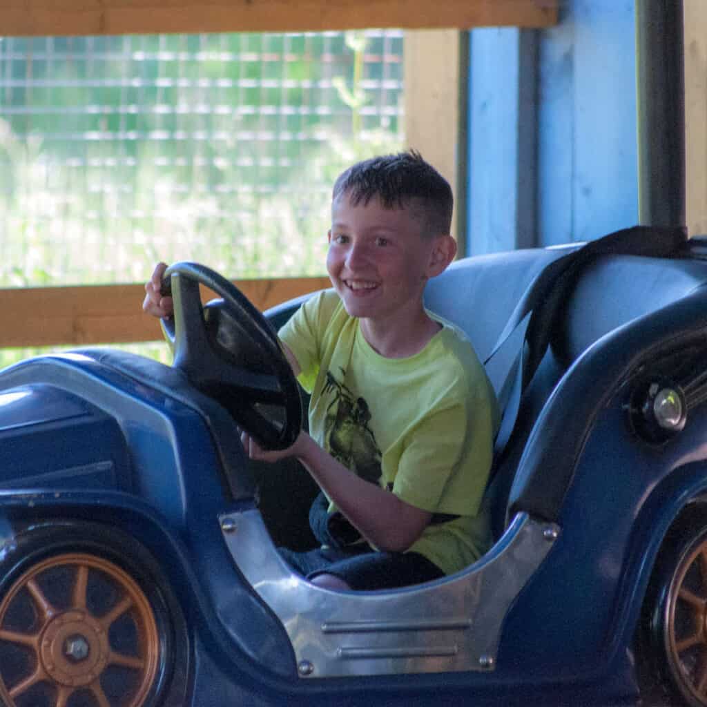 Young boy in blue dodgems car