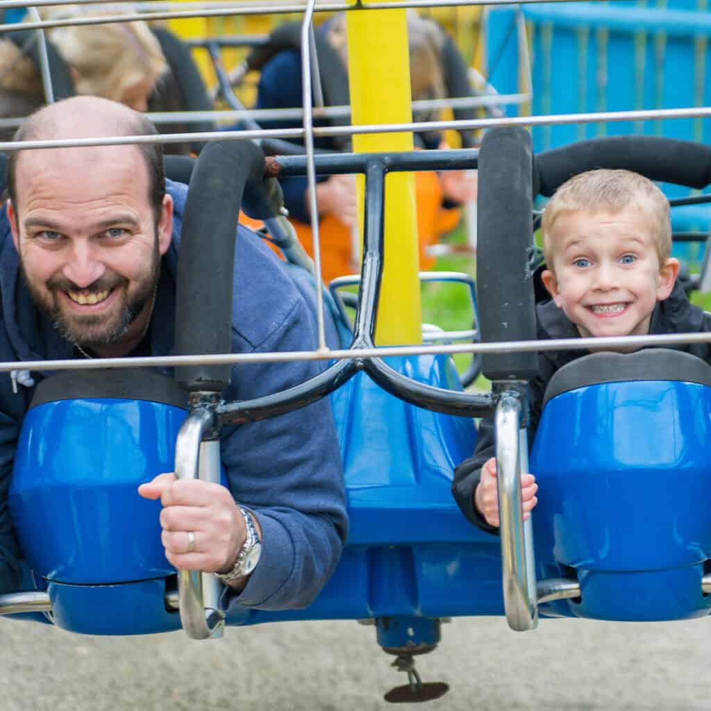 Man and a young boy on a theme park ride