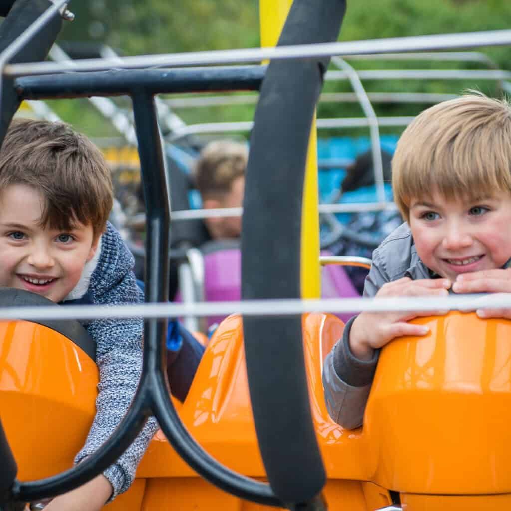 Two young boys on a theme park ride
