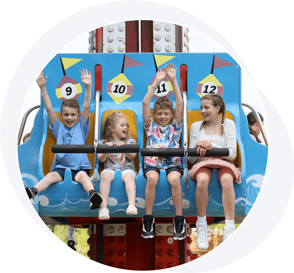 Children on a drop tower ride