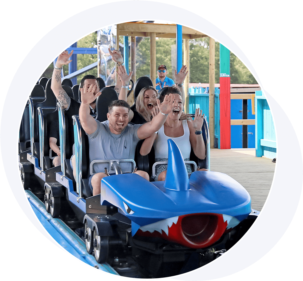 People excited on a roller coaster