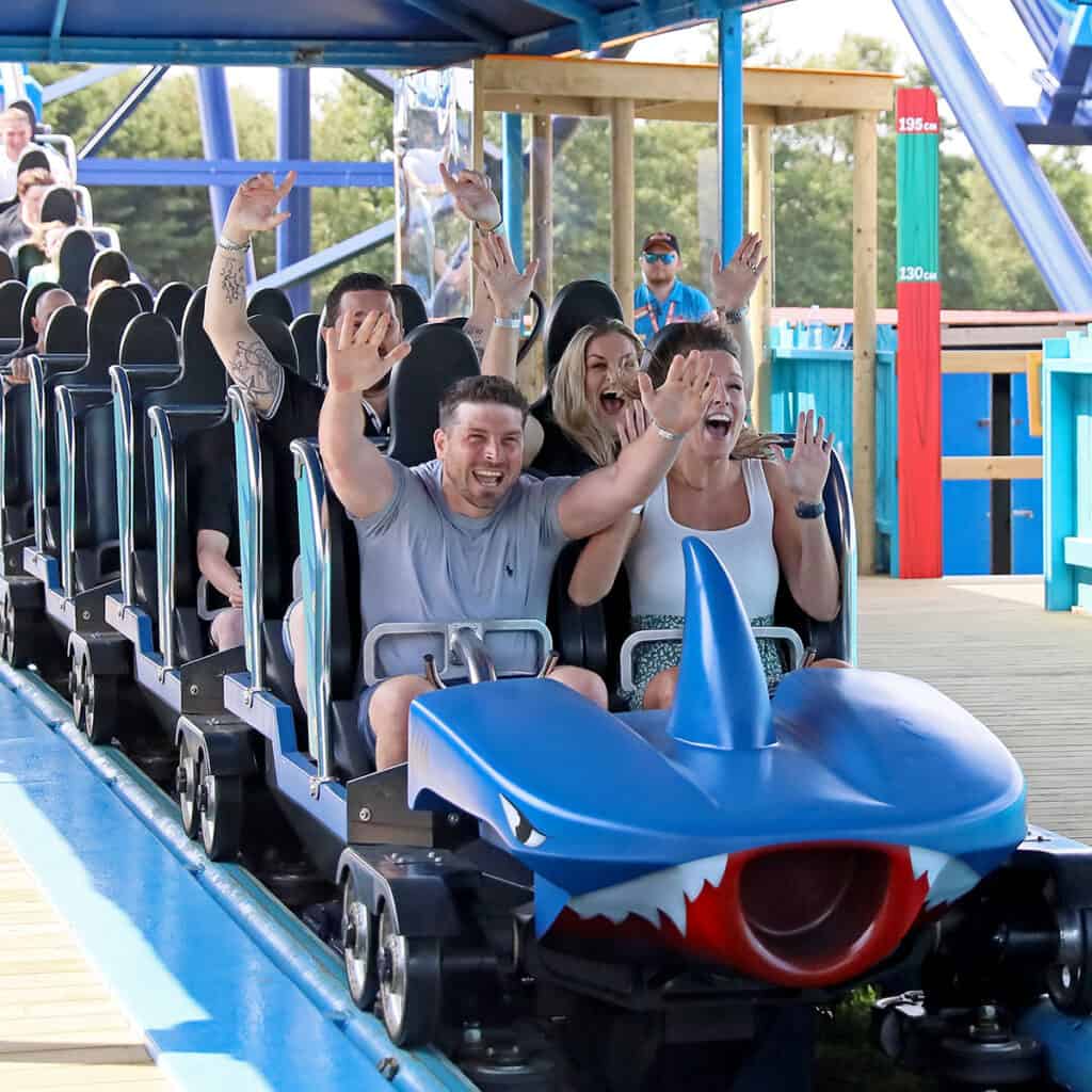 People on a blue rollercoaster