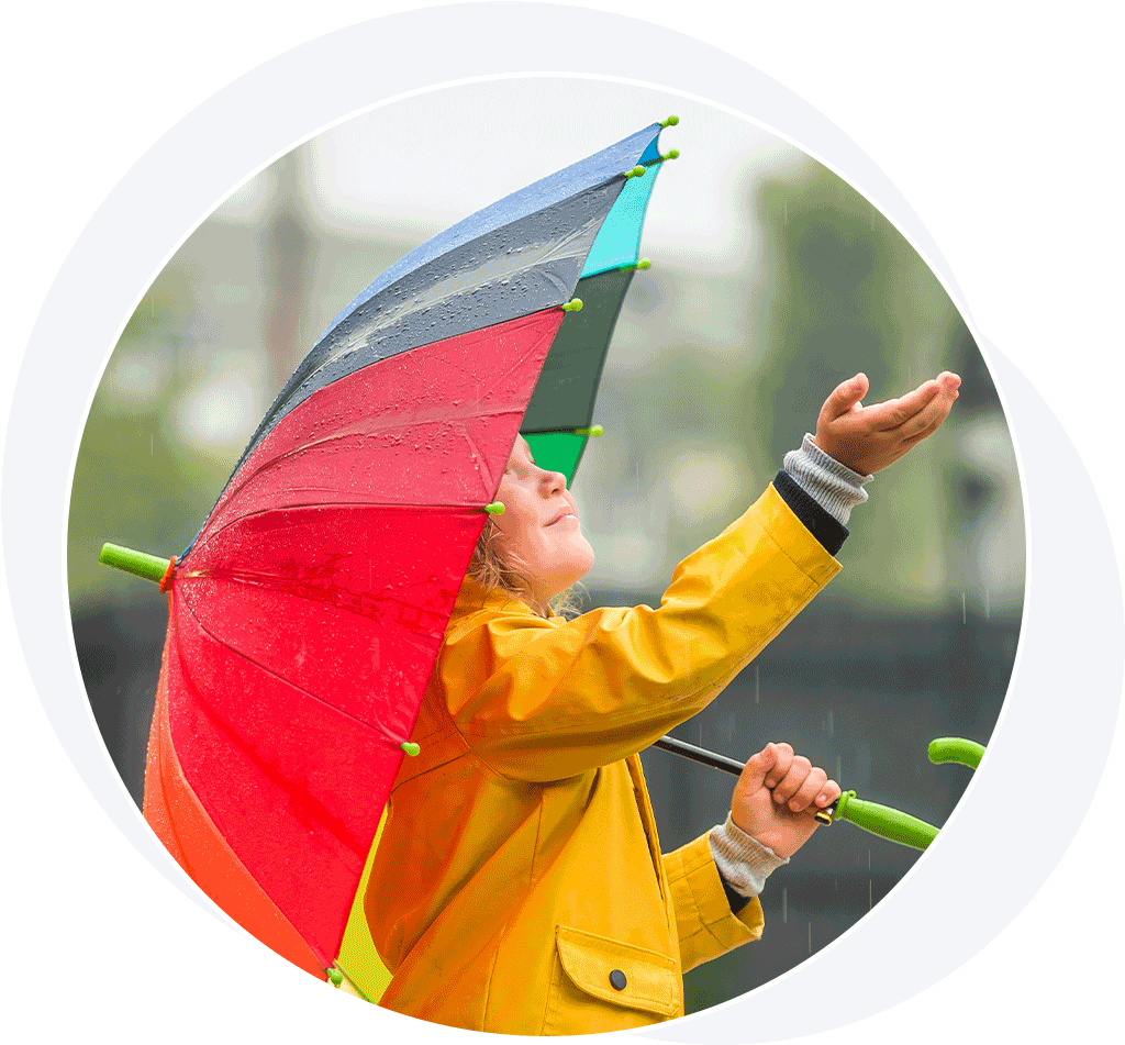 Young girl holding umbrella in the rain