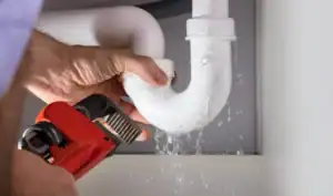 Plumber-Repairing-Leaking-PVC-Pipe