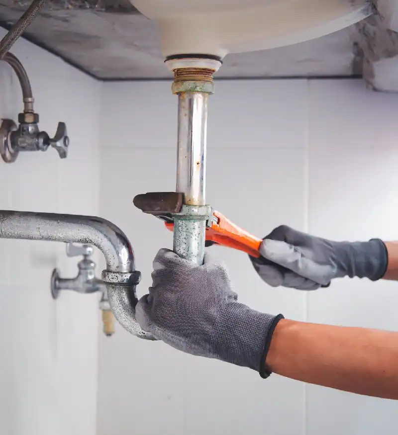 Plumber Repairing Sink Drain Pipe