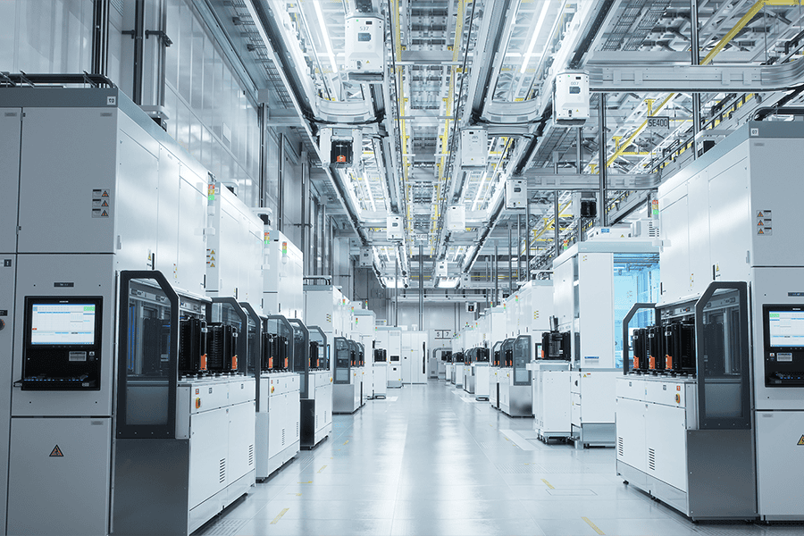 Automated cleanroom facility with rows of manufacturing equipment used for high‑precision production.