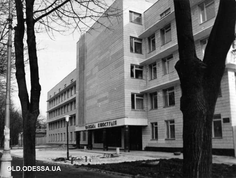Будівля Одеської кіностудії з деревами на передньому плані.