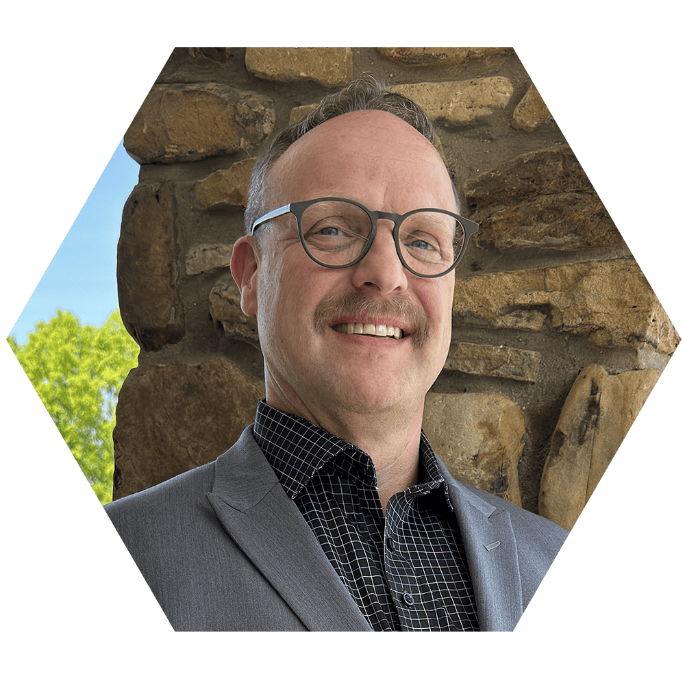 A professional portrait of Kyle Mavin.