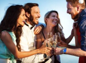 Friends enjoying a yacht after party with champagne on a boat.