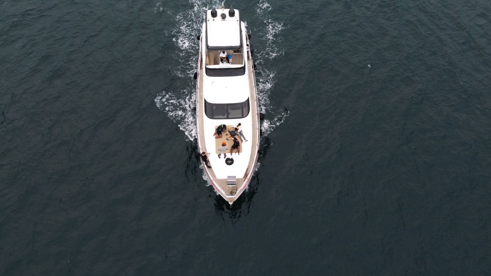 Overhead view of the P114 motor yacht moored along the Bosphorus shoreline in Istanbul.