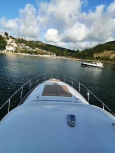 Front deck of the P114 19m motor yacht with sun pad and teak flooring.