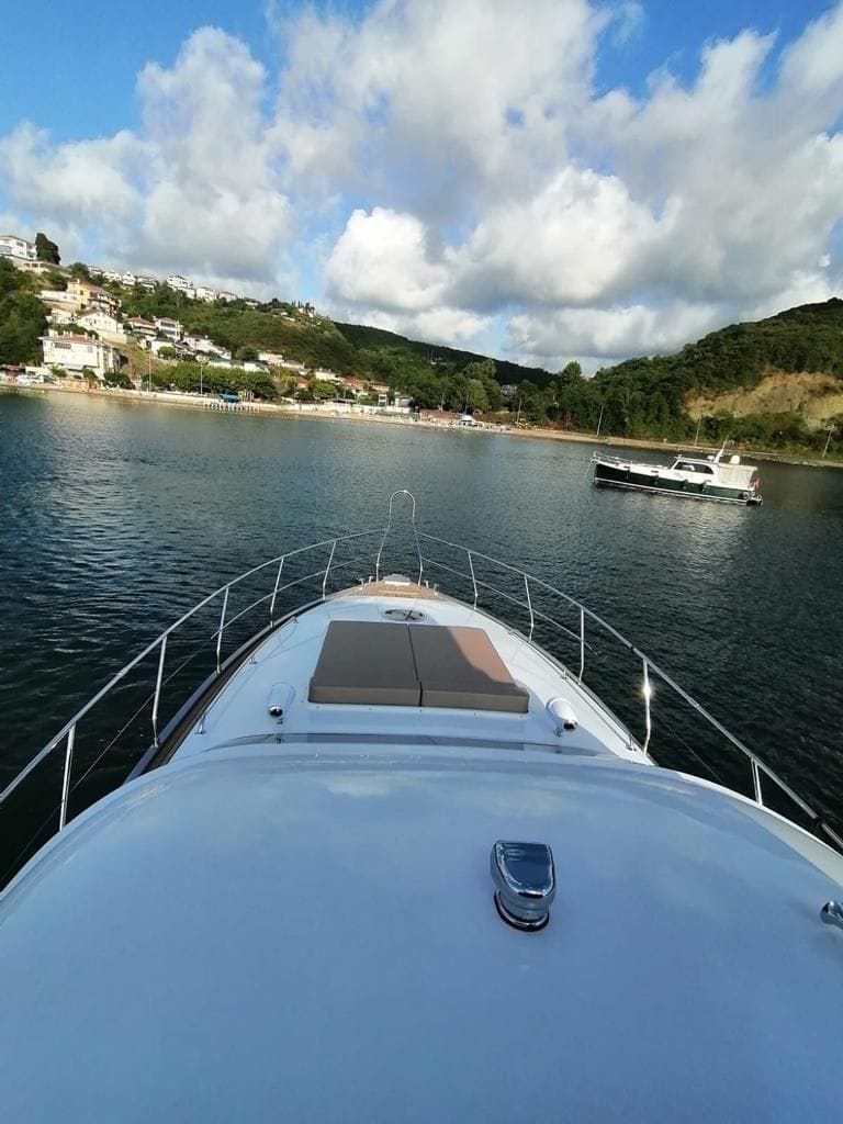 Front deck of the P114 19m motor yacht with sun pad and teak flooring.