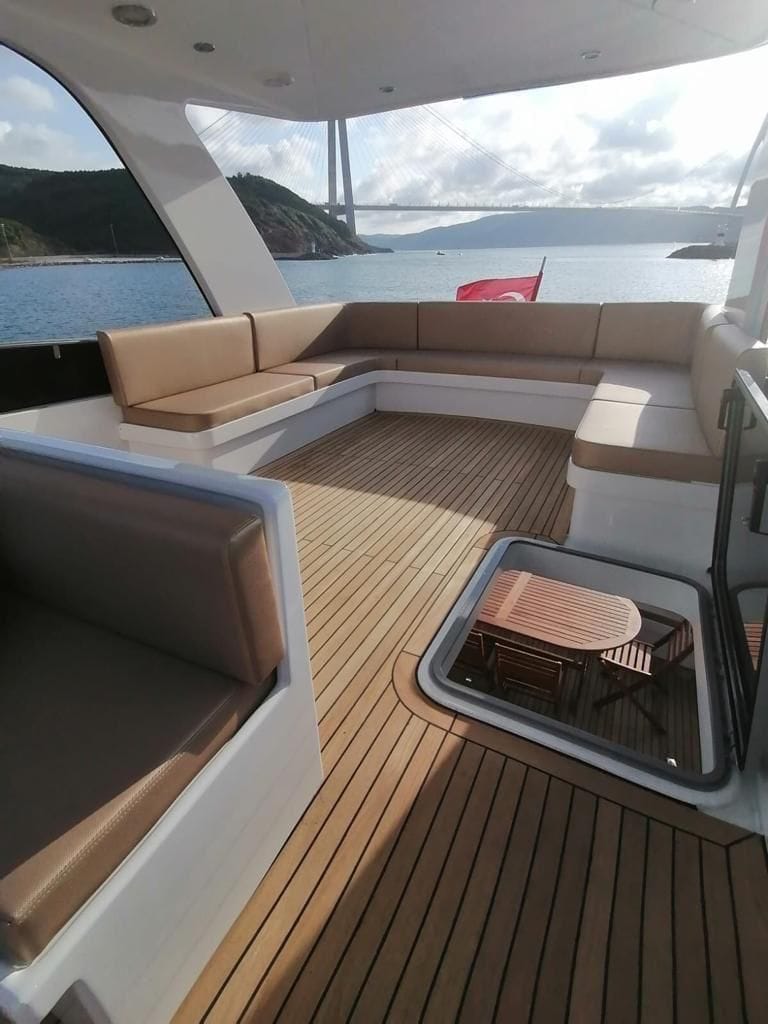 Front deck of the P114 19m motor yacht with sun pad and teak flooring.