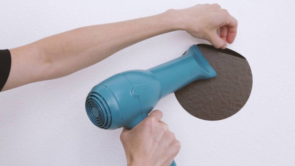 How to remove Custom printed Stickers from walls?