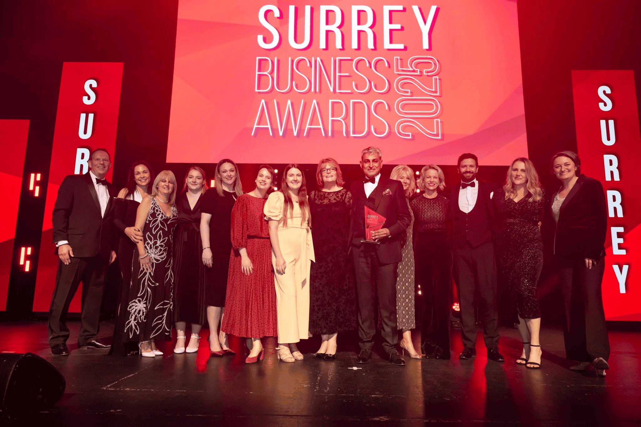 Award-winning Private GP Clinic team receiving Surrey Business Awards 2022 recognition in West Byfleet, Sunningdale, and Reigate. Highly professional healthcare services at prestigious event.