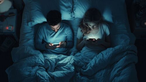 couple on phones in bed