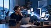 Man working with digital devices and publishing tools in a modern workspace.