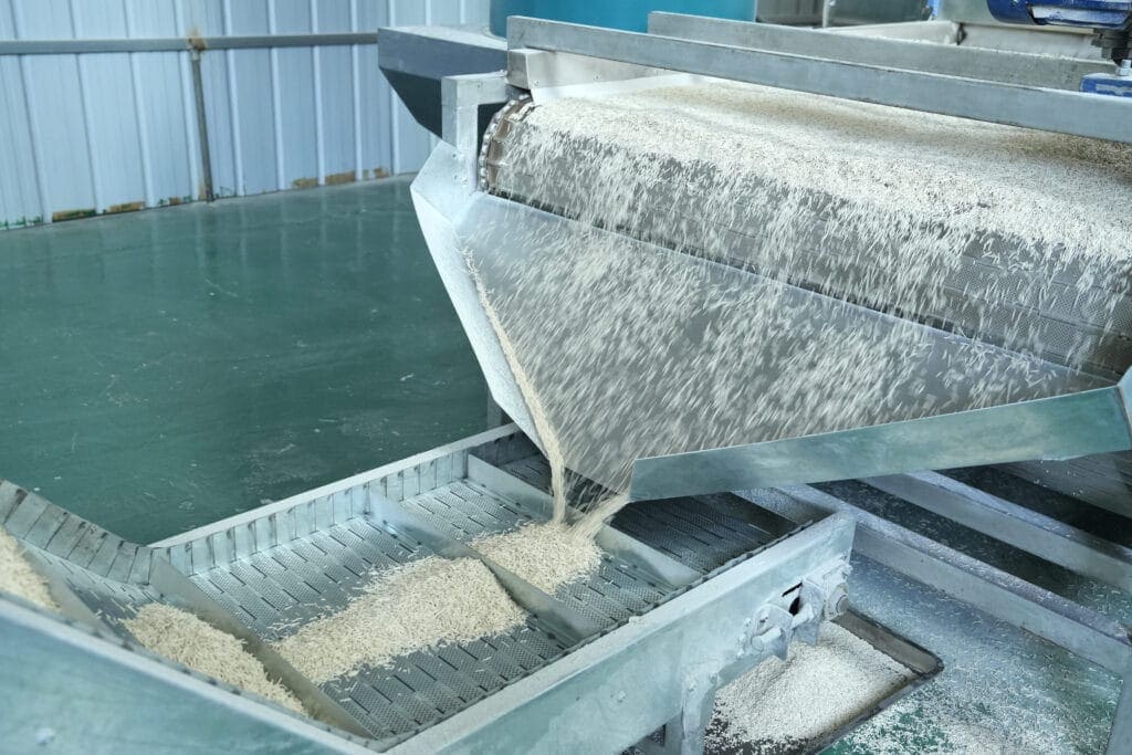 Soft eco-friendly cat litter being processed on industrial machinery at QingkePet plant.