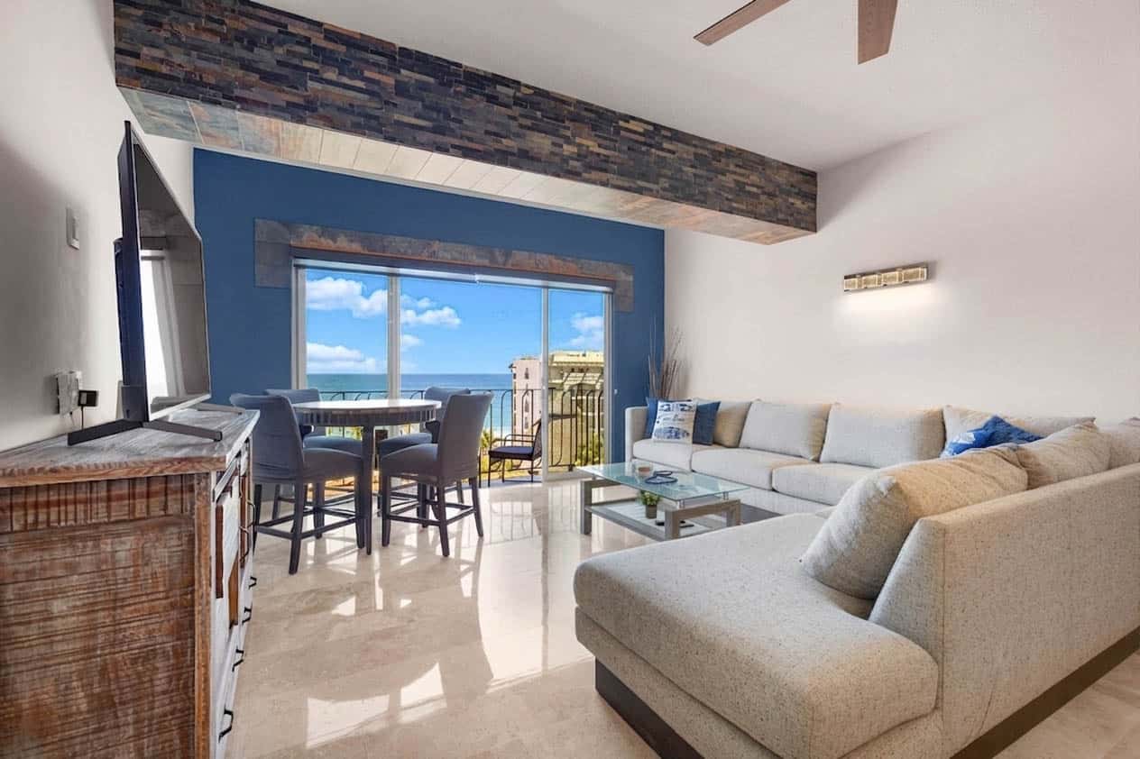 Bright living room in Vista La Jolla Condo 406 with sectional sofa and ocean view
