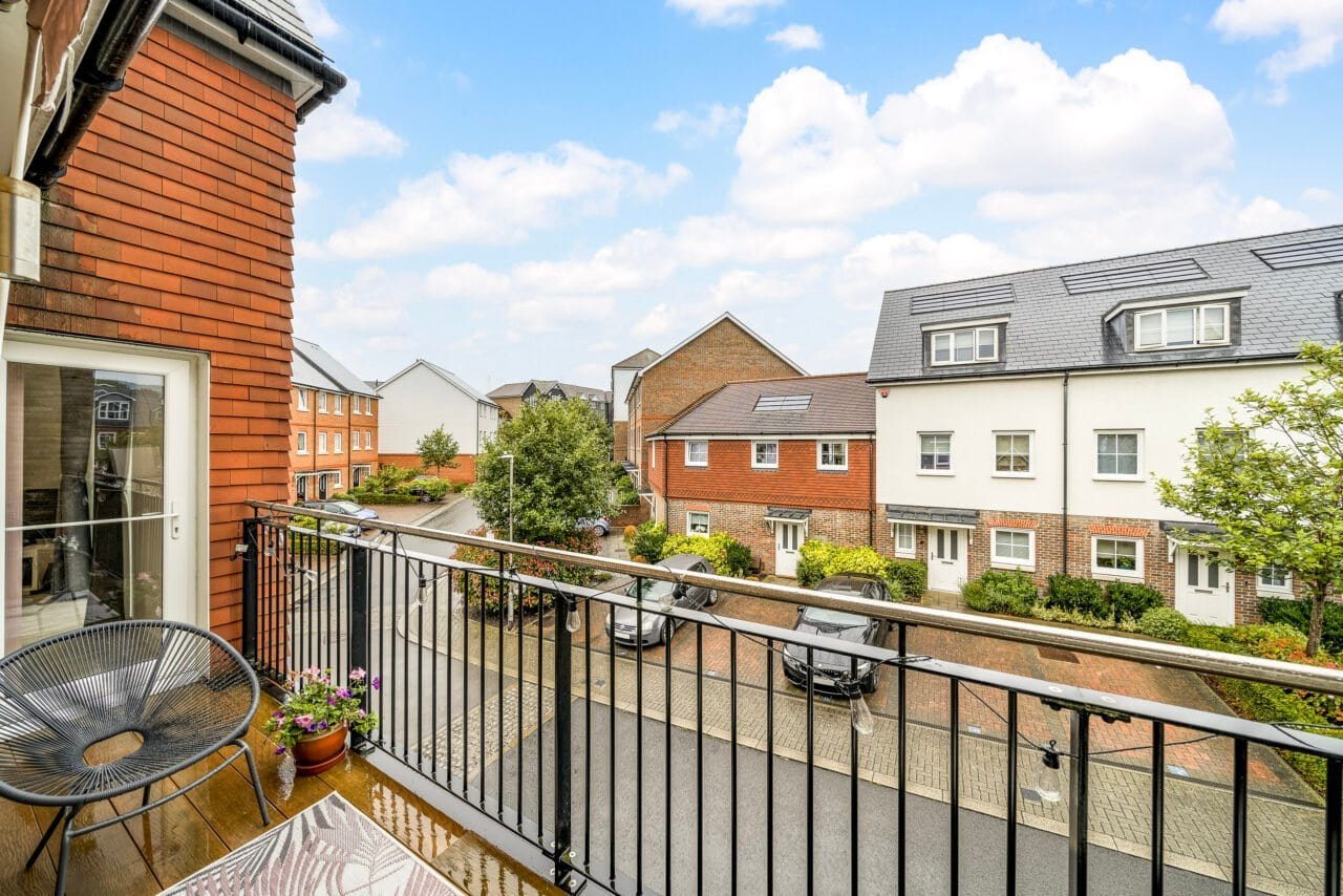 A balcony view of residential houses and street in a suburban neighbourhood.