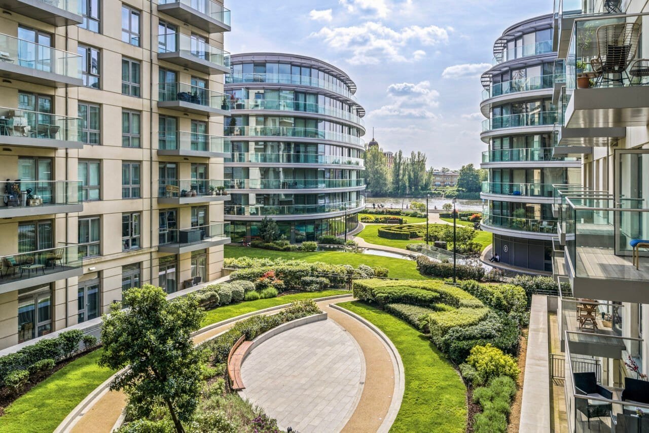 Modern residential apartments with landscaped gardens and curved glass facades.