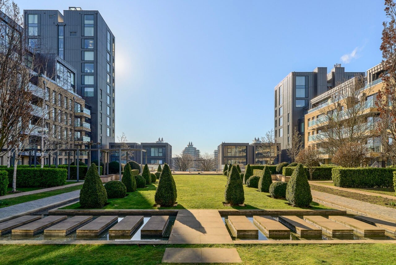 A modern residential complex with landscaped gardens and contemporary apartment buildings.