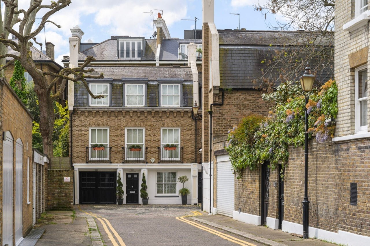 Modern brick townhouse with garage and garden in a quiet residential street.