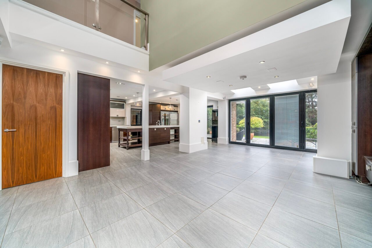 Spacious modern living room with large glass doors and contemporary design.