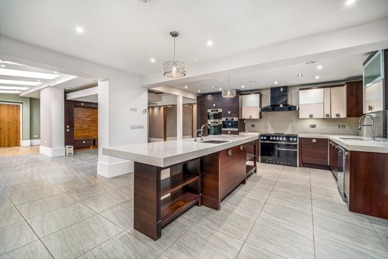 Modern open-plan kitchen with island, stainless steel appliances, and contemporary design.