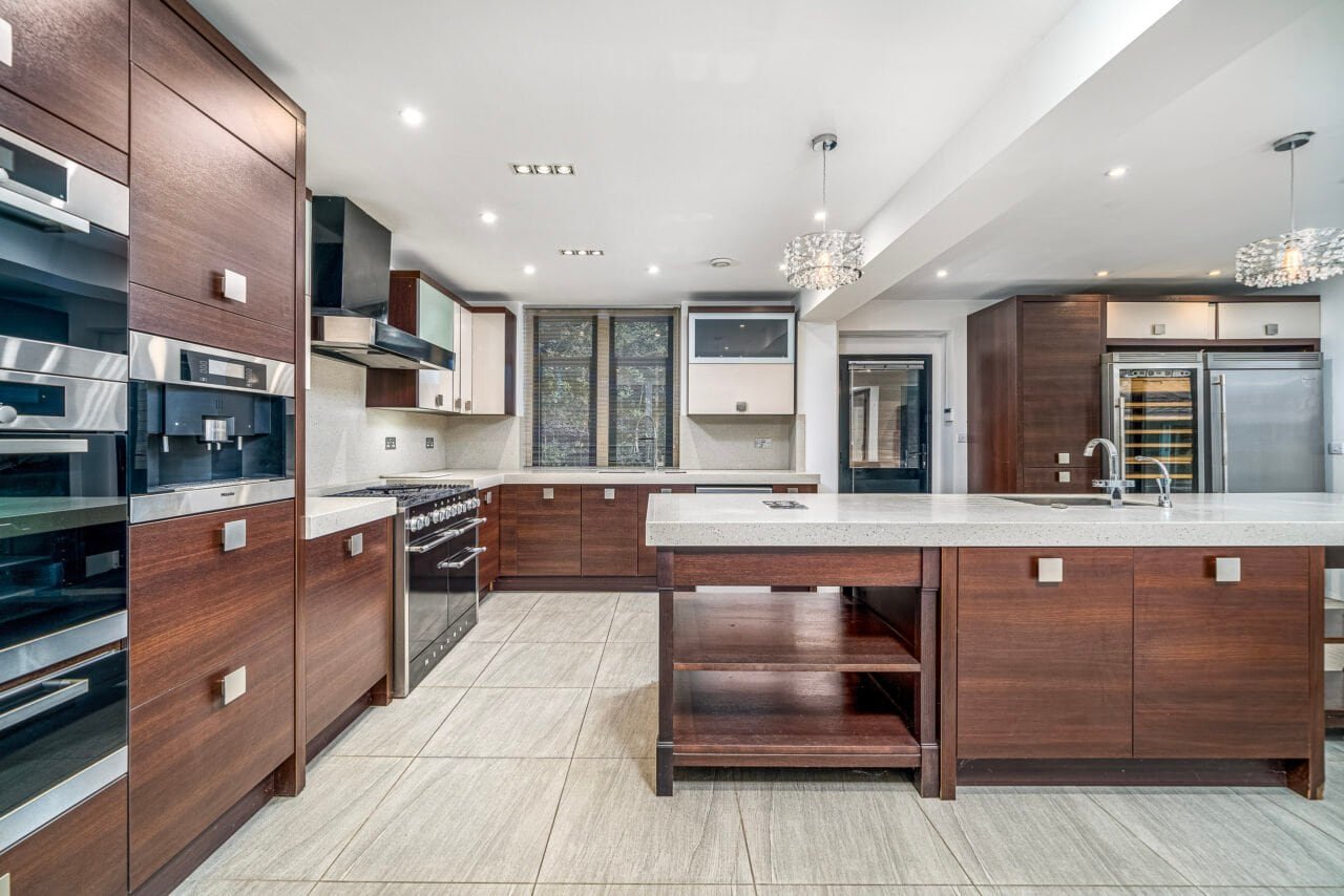Modern kitchen with wooden cabinets, stainless steel appliances, and island counter.